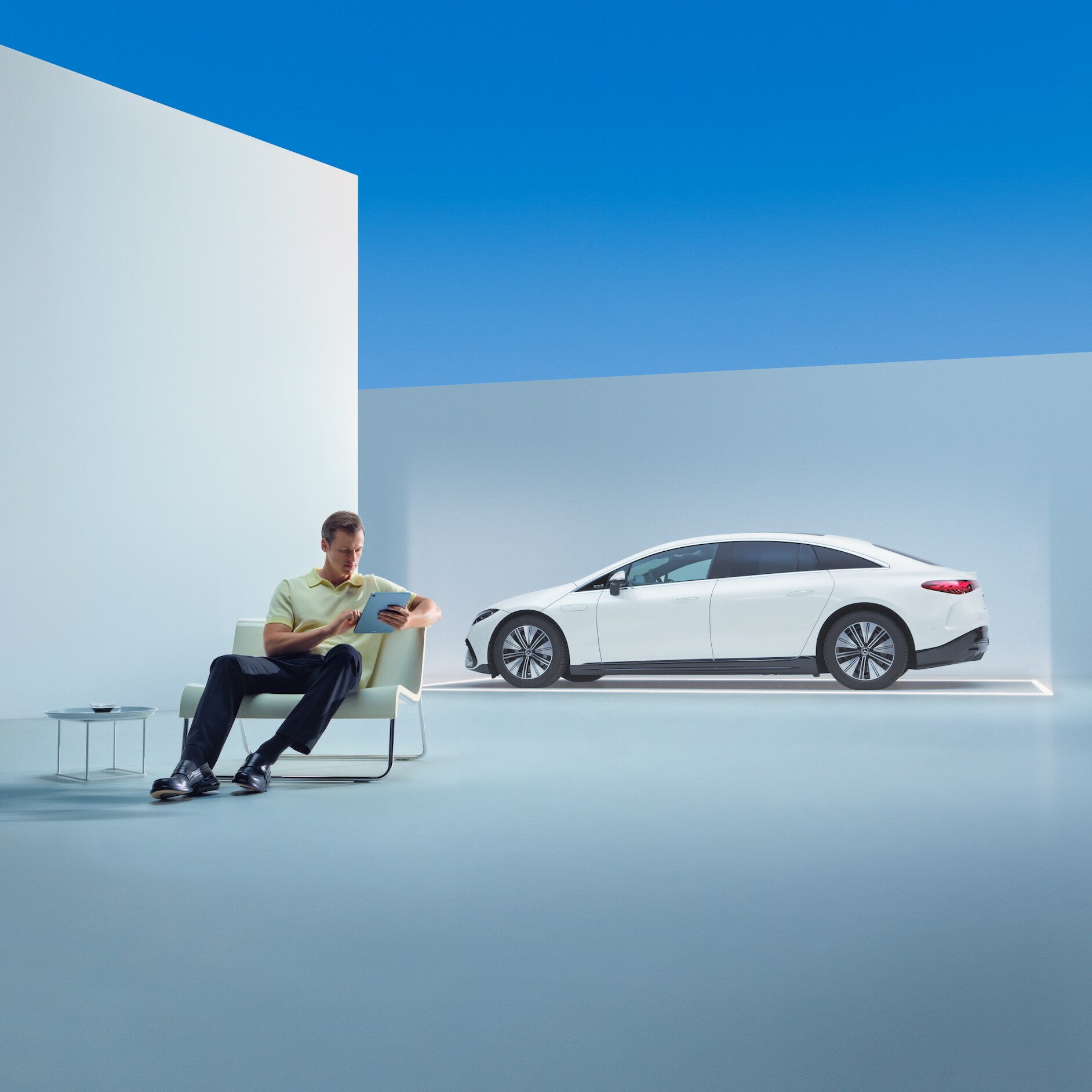 Have a safe journey with the Mercedes-Benz warranty for new vehicles. | Mercedes-Benz A relaxed man is sitting in front of his Mercedes with his tablet.