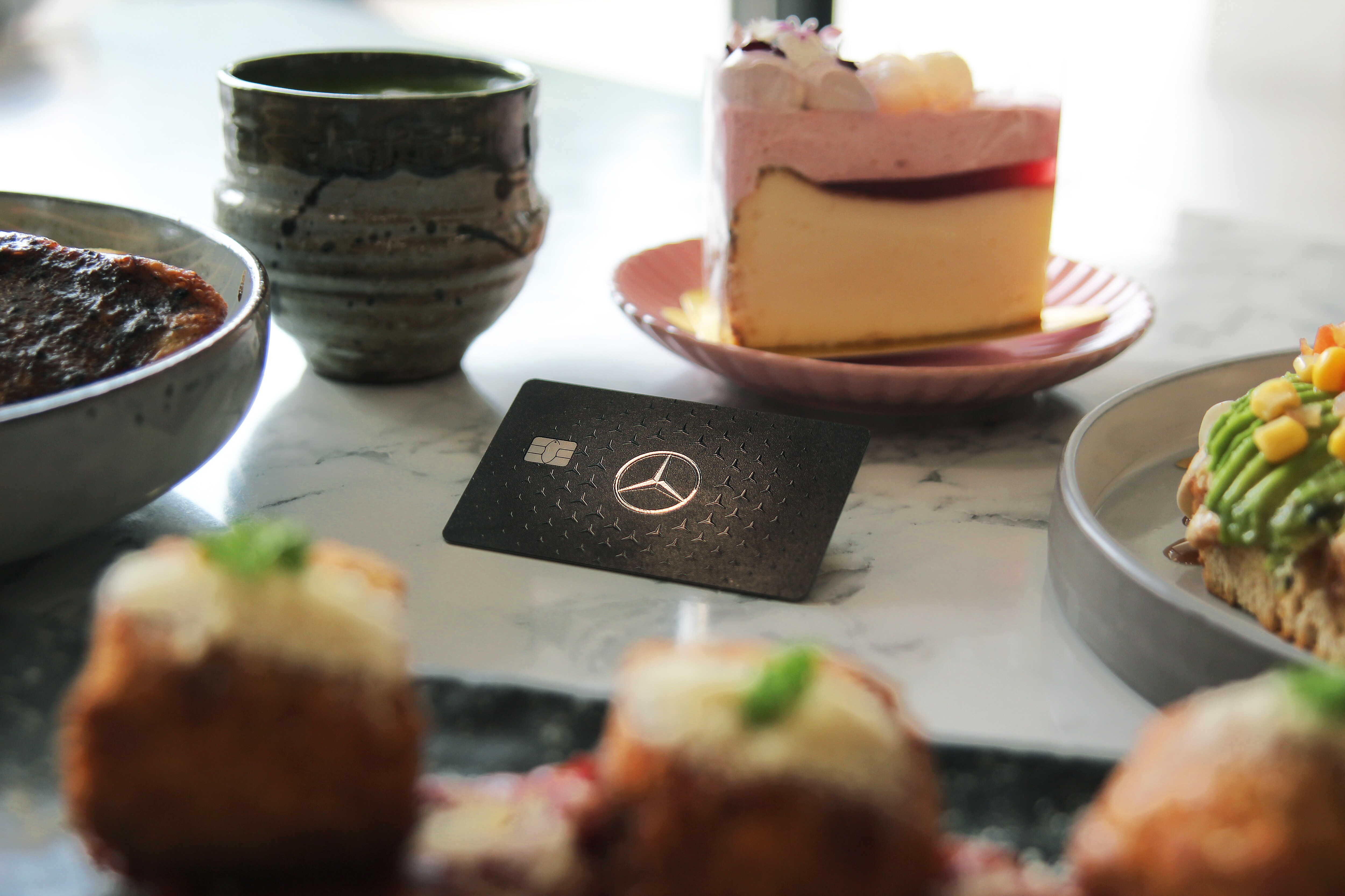 Mercedes-Benz Card | Brand | Mercedes-Benz A Mercedes-Benz card on a dining table surrounded by food