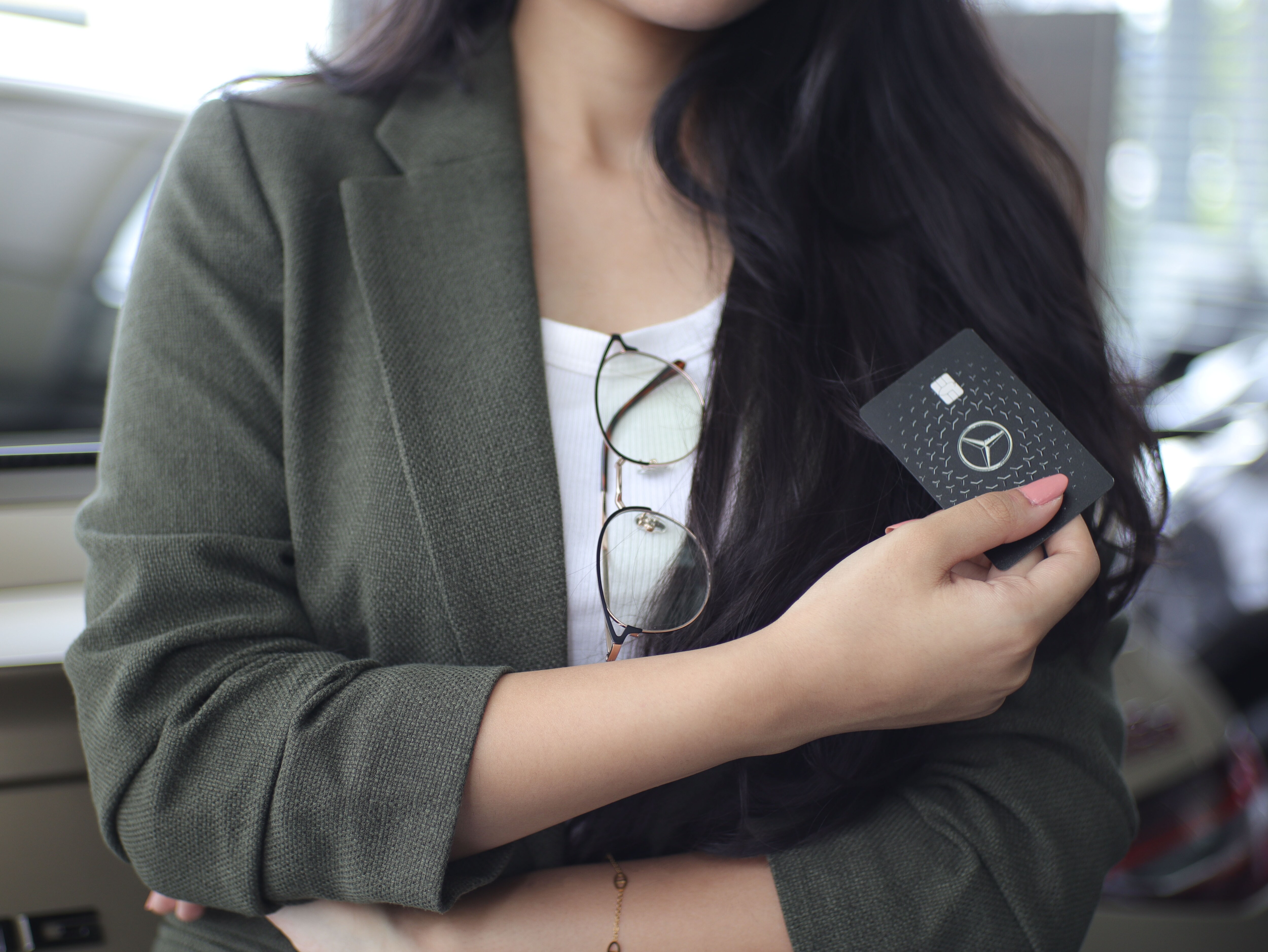 Mercedes-Benz Card | Brand | Mercedes-Benz A woman holding a Mercedes-benz card