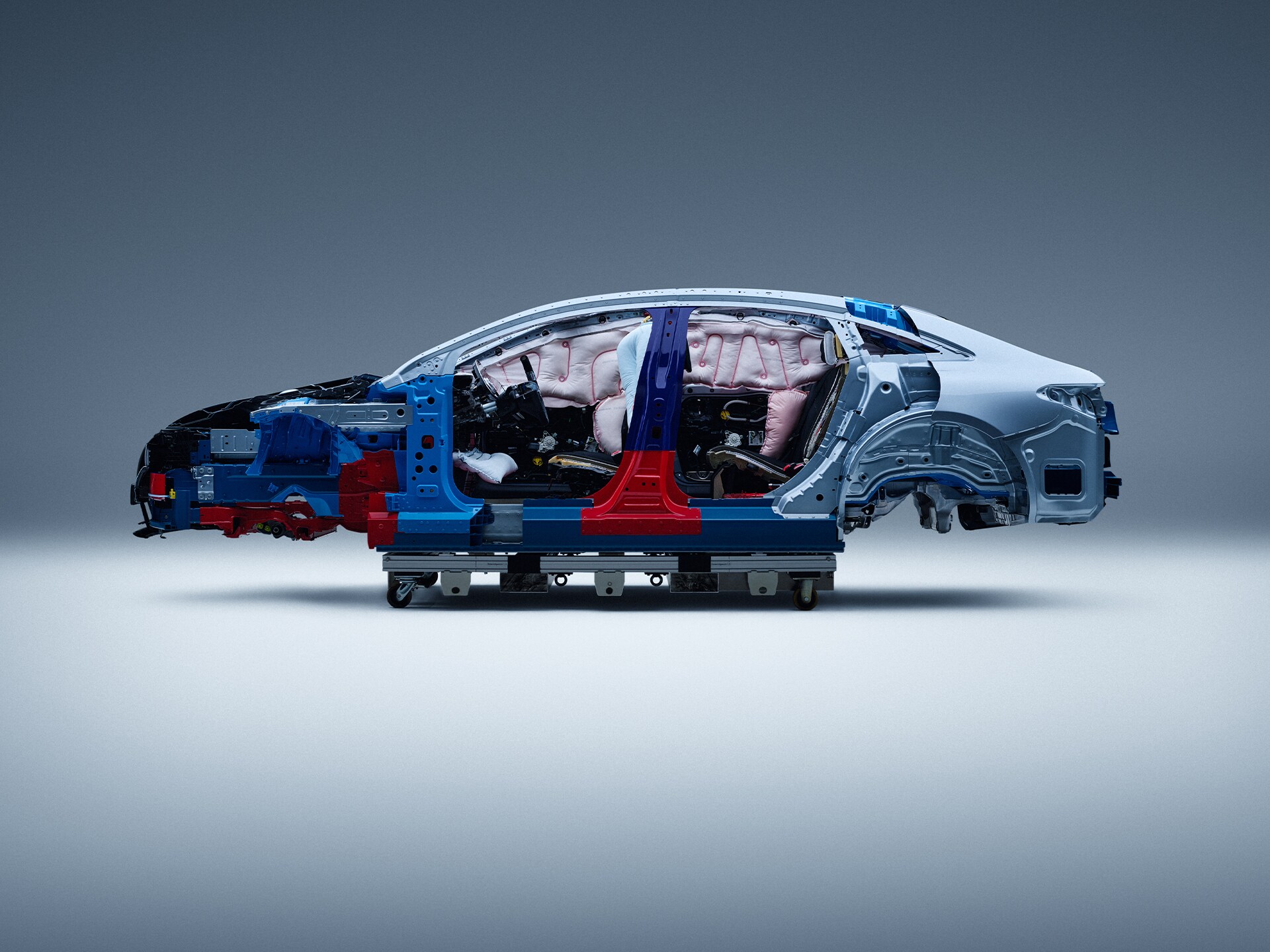 Safety | Mercedes-Benz Side view of a partially disassembled Mercedes-Benz car for safety research.